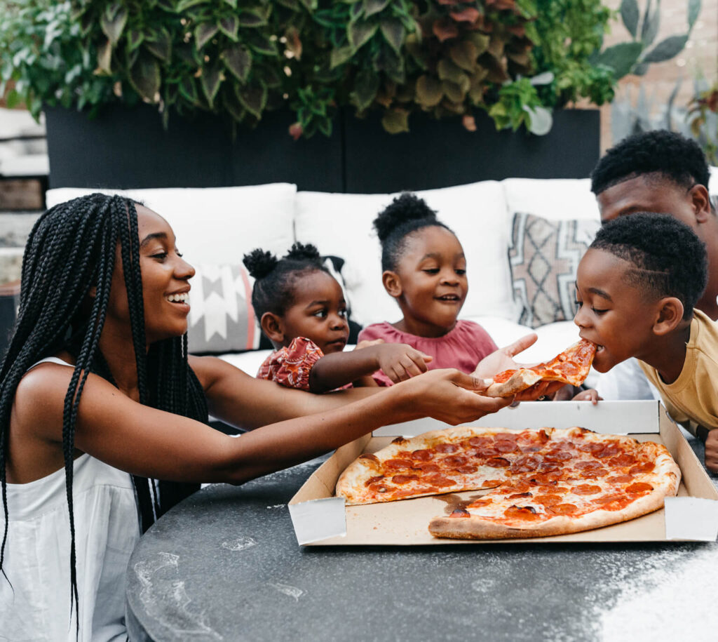 A family eating pizza